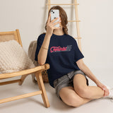 Woman sitting wearing Feminist AF pink and white graphic T-shirt